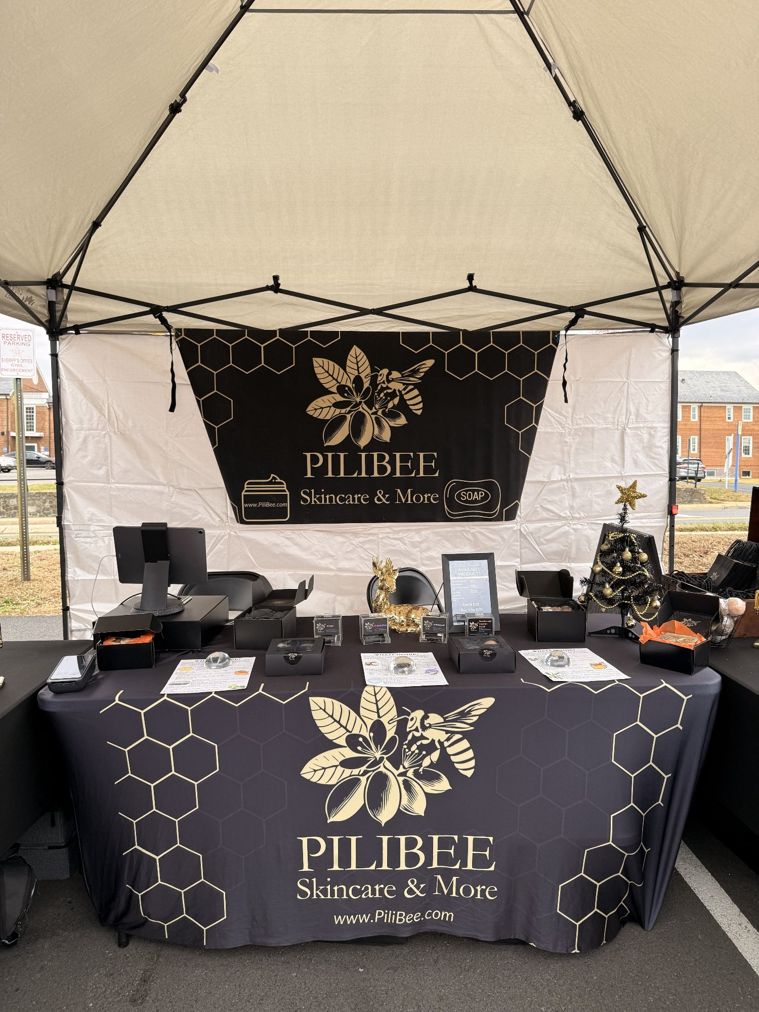 Pilibee skincare and more booth setup with branded tablecloth and backdrop