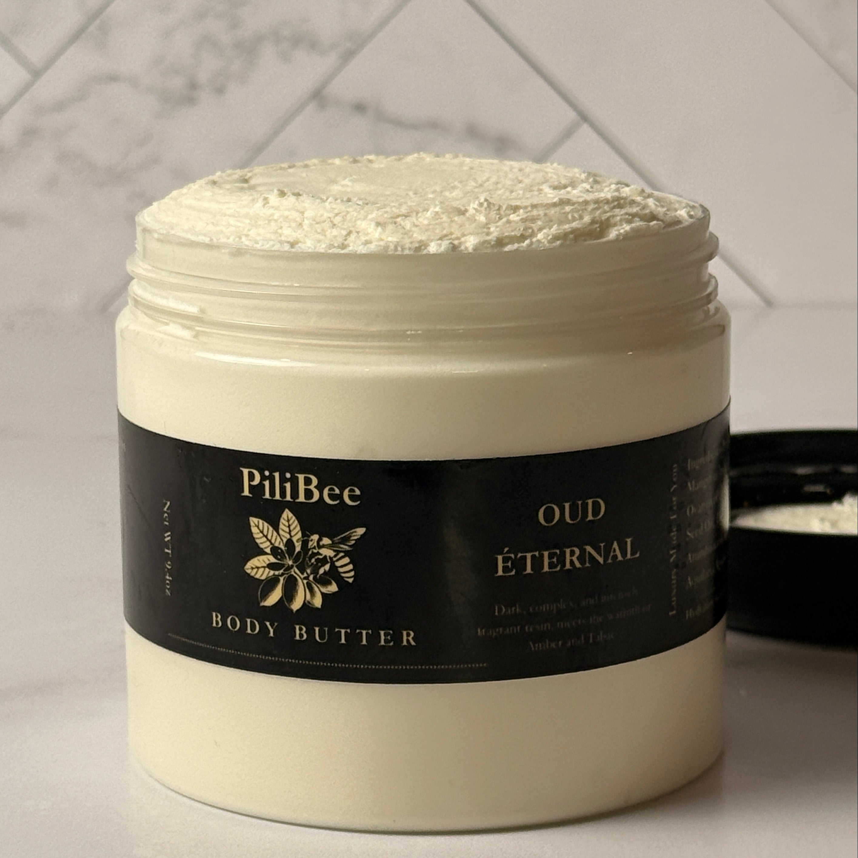 PiliBee Oud Eternal body butter jar on a neutral background