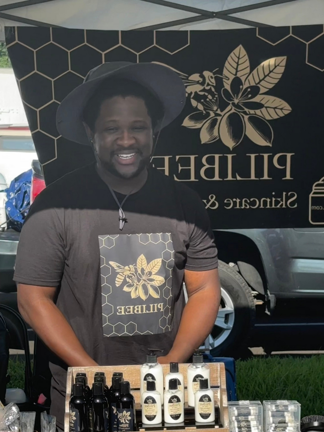 Person standing behind a table with products at a Pillwee booth