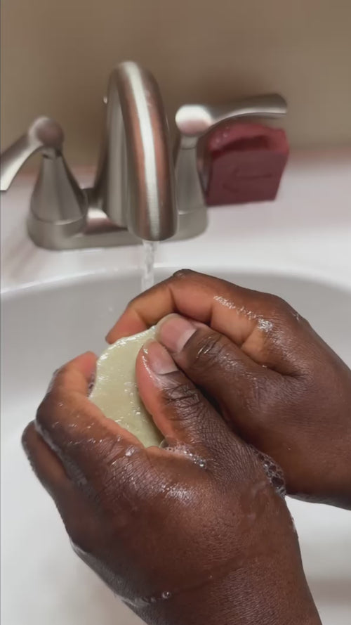 Washing hands using a bar of pilibee soap. video repeats and loops. 